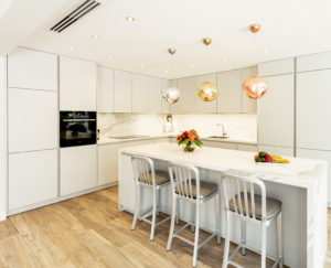 Kitchen Island in White and Grey Kitchen on Parquet floor in Dubai by Goettling interiors