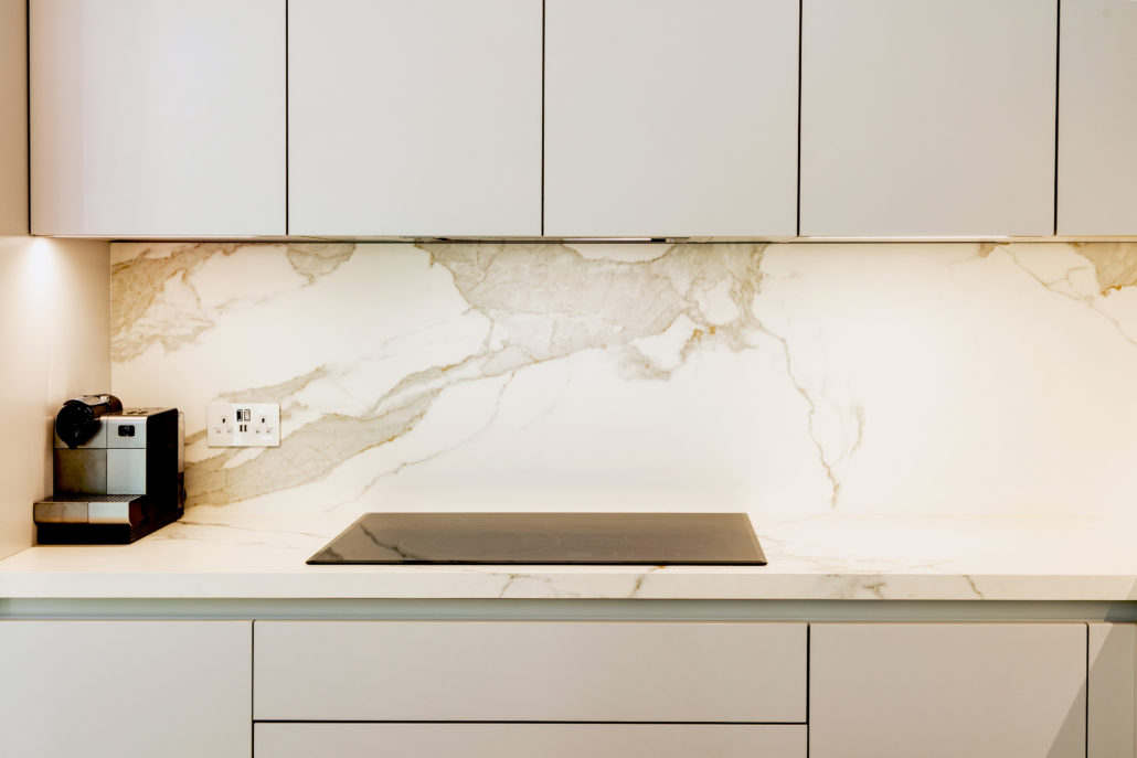 Kitchen Island in White and Grey Kitchen on Parquet floor in Dubai by Goettling interiors