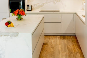 Kitchen Island in White and Grey Kitchen on Parquet floor in Dubai by Goettling interiors