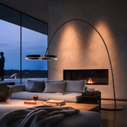 Couple standing by the window. Occhio floor light in the foreground.